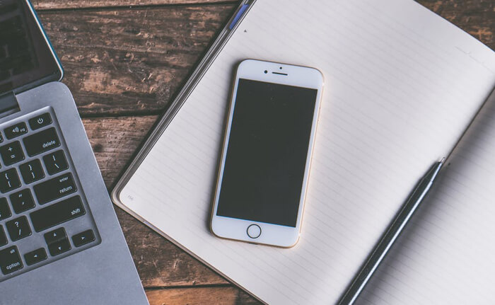 Desk with a mobile phone and a laptop
